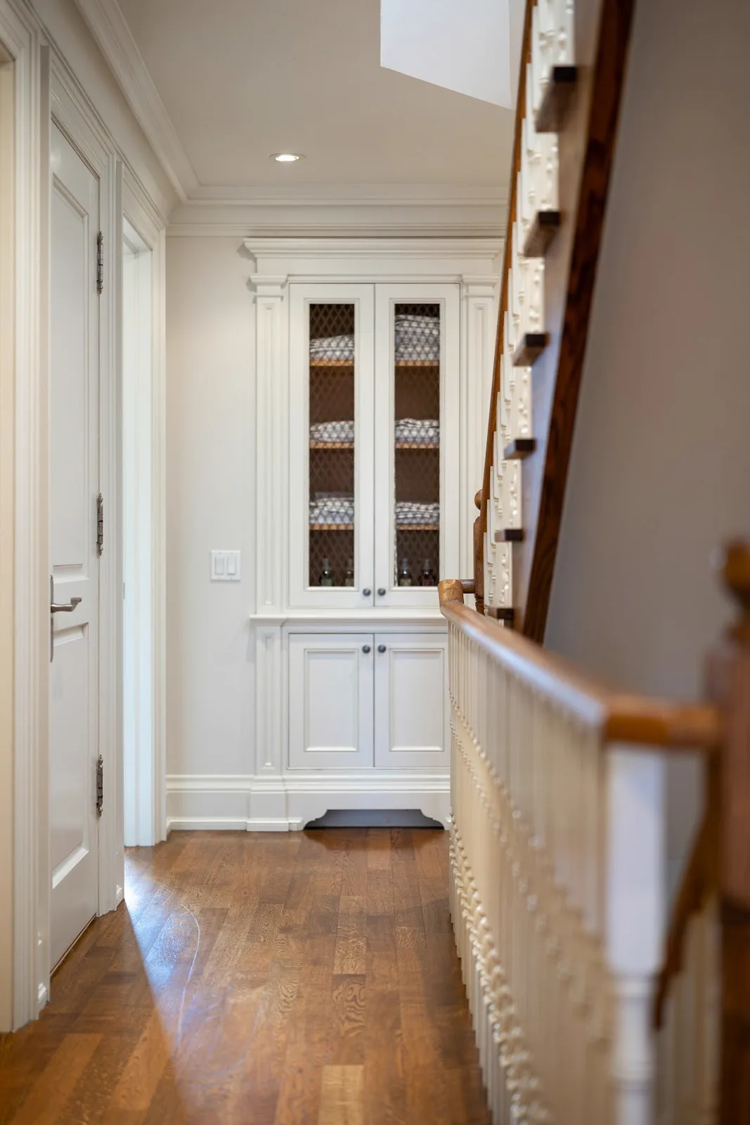 Built-in cabinet and hutch refinished in crisp white with glass-front doors